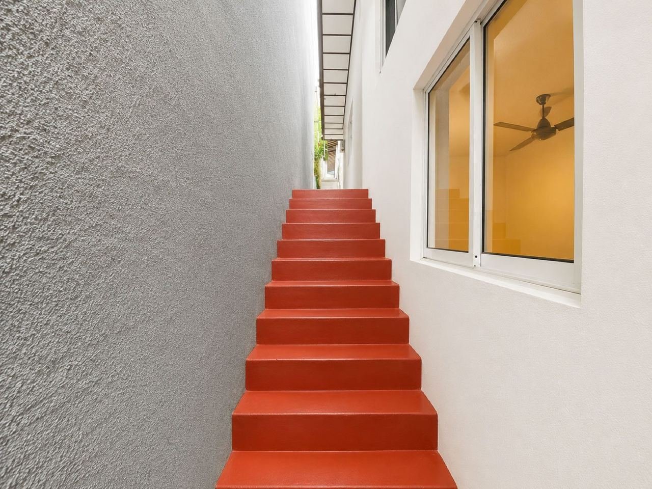 Red stairway to a sunlit opening – Three Houses on One Lot for Sale in Rajagiriya