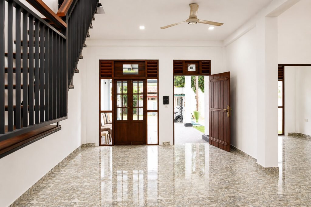 Bright modern entryway with floating staircase and garden door access