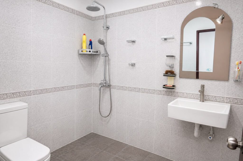 Modern bathroom with geometric floor tiles and contemporary fixtures and vanity