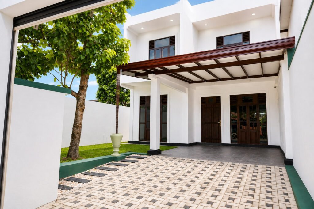 Modern two-storey house exterior in Kesbewa with paved frontage and garden